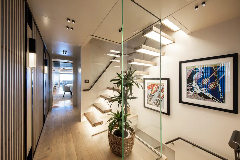 Oscar Yacht Photos Pics Modern interior of 2023 Numarine 37XP yacht with stylish staircase and artwork.