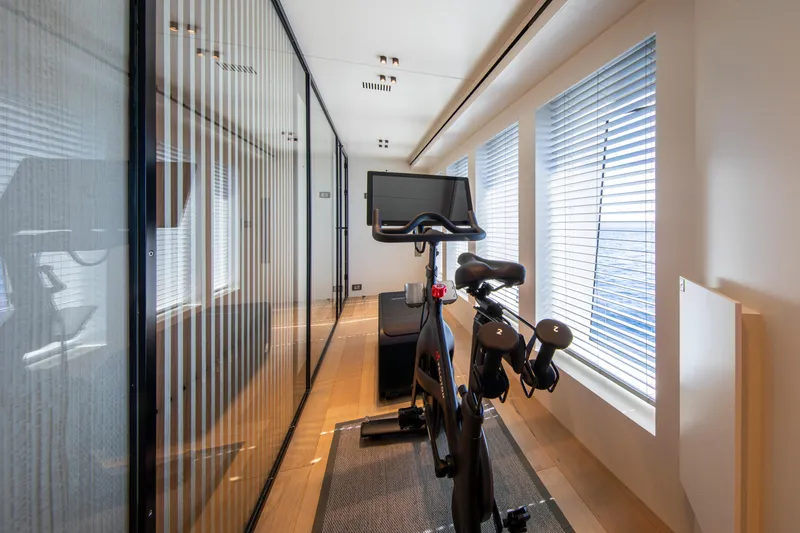 Oscar Yacht Photos Pics Exercise bike in modern gym on 2023 Numarine 37XP yacht with ocean view.