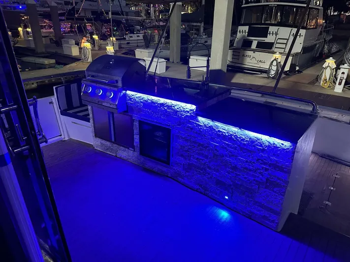 Yacht Photos Pics Outdoor kitchen on 2004 Cheoy Lee 72 yacht with blue LED lighting at marina.