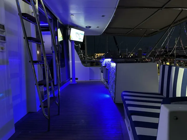  Yacht Photos Pics Luxurious 2004 Cheoy Lee 72 yacht interior with blue LED lighting and striped seating.