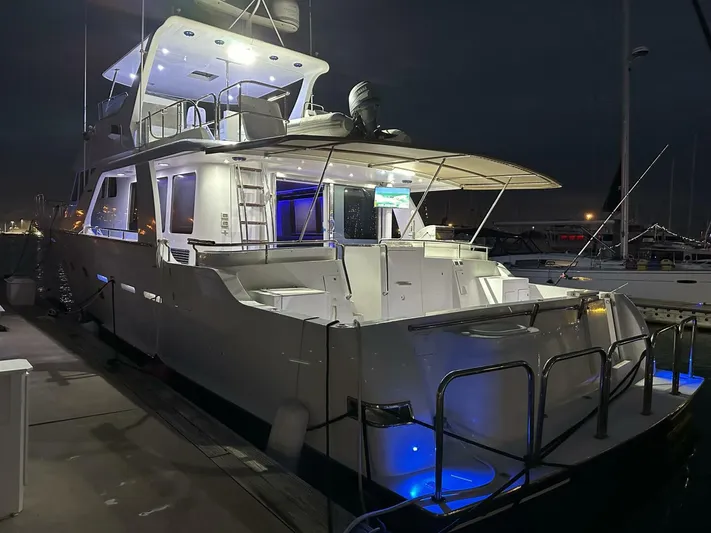  Yacht Photos Pics 2004 Cheoy Lee 72 yacht docked at night with illuminated deck and modern design.