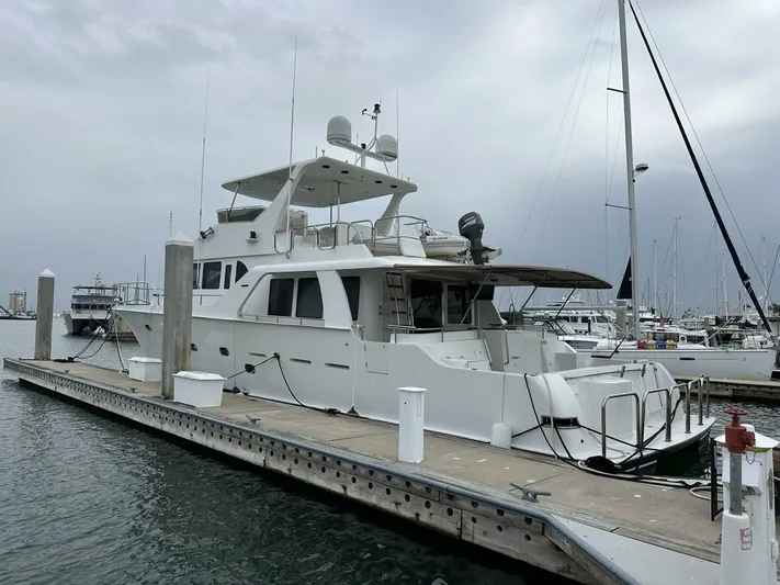 Yacht Photos Pics 2004 Cheoy Lee 72 yacht docked at marina under cloudy sky.