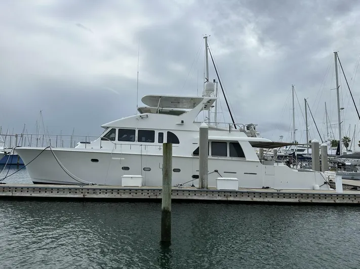  Yacht Photos Pics 2004 Cheoy Lee 72 yacht docked at marina under cloudy sky.