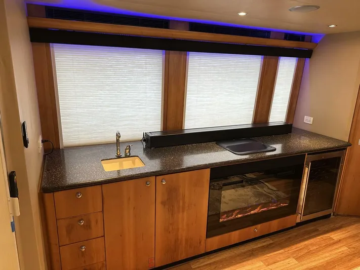  Yacht Photos Pics Luxurious Cheoy Lee 72 yacht kitchen interior with modern appliances, wood cabinetry, and ambient lighting, 2004 model.