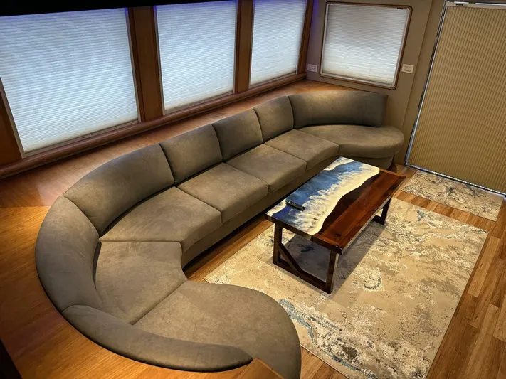  Yacht Photos Pics Luxurious interior of 2004 Cheoy Lee 72 yacht with curved sofa and elegant coffee table.