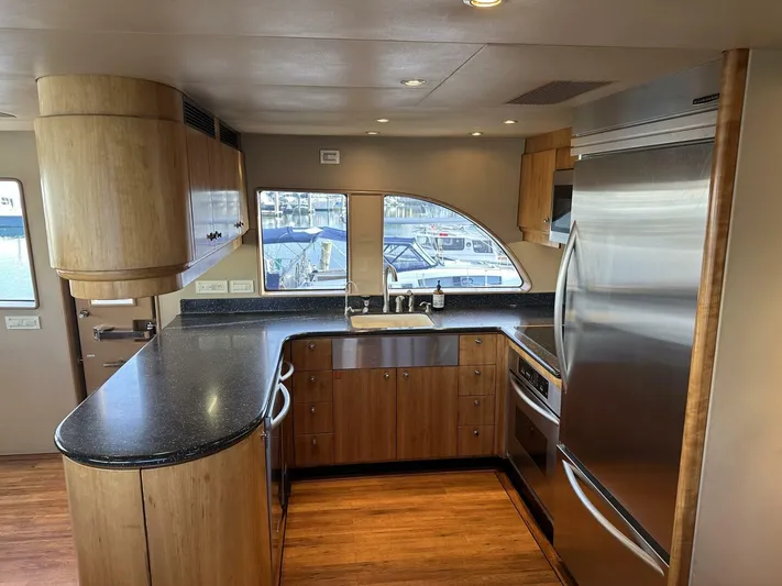  Yacht Photos Pics Luxurious kitchen interior of 2004 Cheoy Lee 72 yacht with modern appliances and wood finish.
