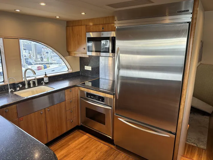  Yacht Photos Pics Luxurious kitchen in 2004 Cheoy Lee 72 yacht with stainless steel appliances and wood cabinetry.