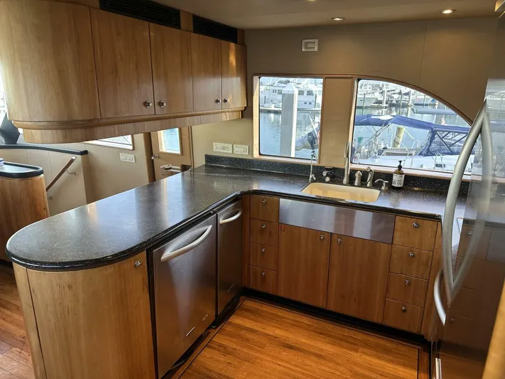  Yacht Photos Pics Luxurious kitchen interior of 2004 Cheoy Lee 72 yacht with modern wood cabinetry.