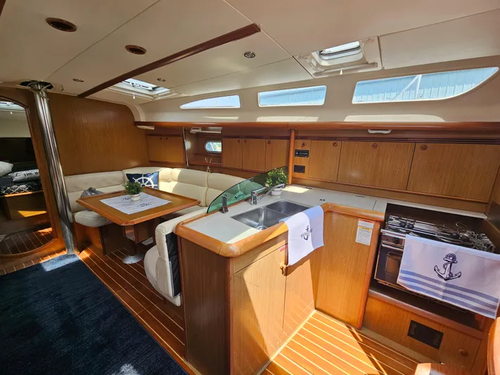 Cherish The Day Yacht Photos Pics Luxurious interior of 2006 Jeanneau Sun Odyssey 40.3 yacht with wood finish and modern amenities.