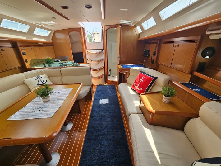 Cherish The Day Yacht Photos Pics Luxurious interior of 2006 Jeanneau Sun Odyssey 40.3 yacht with elegant wood finish and plush seating.