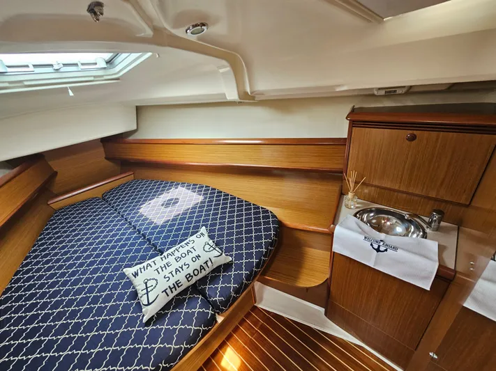 Cherish The Day Yacht Photos Pics Cozy cabin interior of 2006 Jeanneau Sun Odyssey 40.3 with bed and sink.