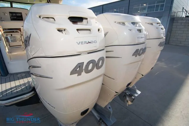  Yacht Photos Pics 2022 Scout 350 LXZ with triple 400 Verado outboard engines at a marina.