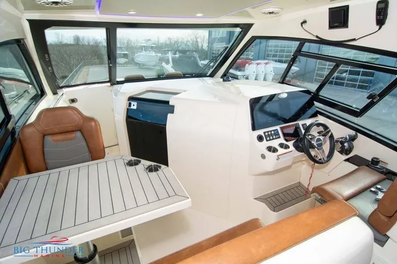  Yacht Photos Pics 2022 Scout 350 LXZ boat interior with modern helm, seating, and table.