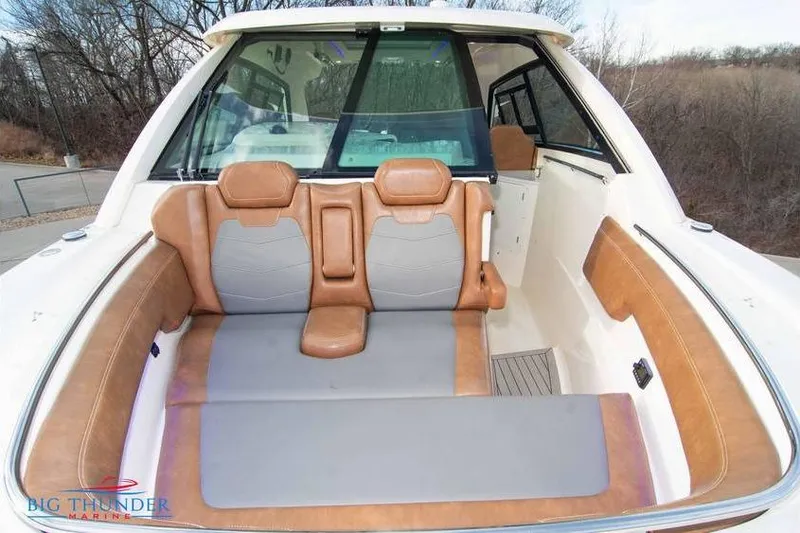  Yacht Photos Pics 2022 Scout 350 LXZ boat interior with tan and gray seating, outdoor setting.