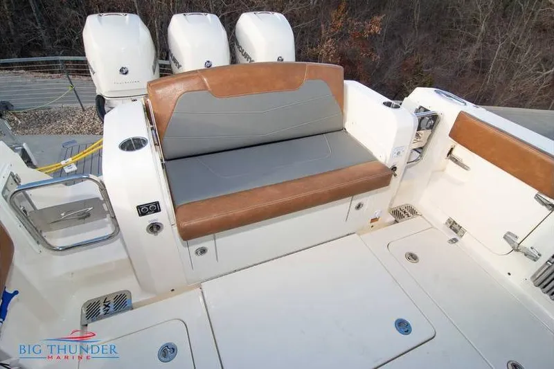  Yacht Photos Pics 2022 Scout 350 LXZ boat with cushioned seating and triple outboard engines.