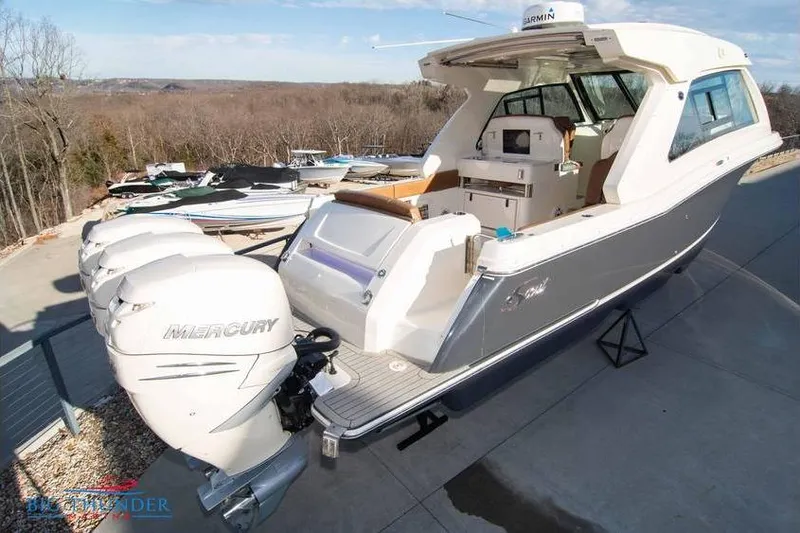  Yacht Photos Pics 2022 Scout 350 LXZ boat with triple Mercury engines, docked outdoors.
