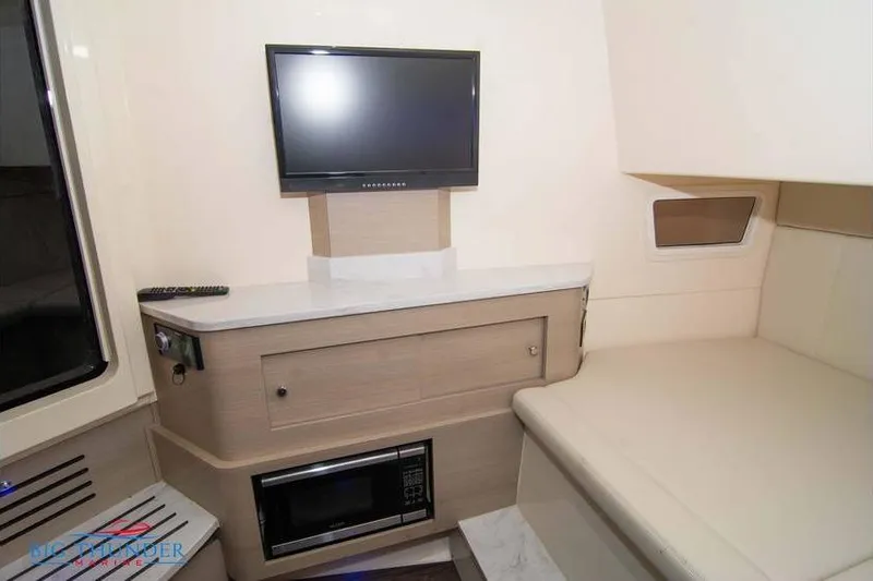  Yacht Photos Pics Interior of 2022 Scout 350 LXZ boat with TV, microwave, and seating area.