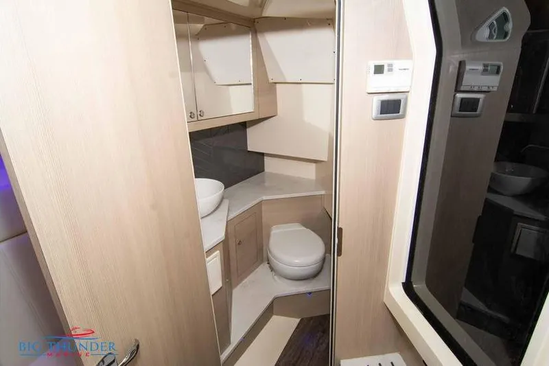  Yacht Photos Pics 2022 Scout 350 LXZ boat interior bathroom with modern fixtures and wood accents.
