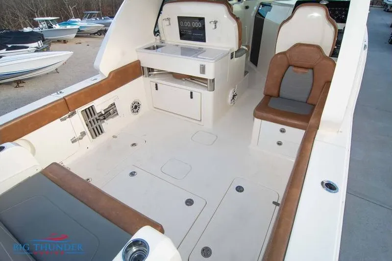  Yacht Photos Pics 2022 Scout 350 LXZ boat interior with seating and control panel.