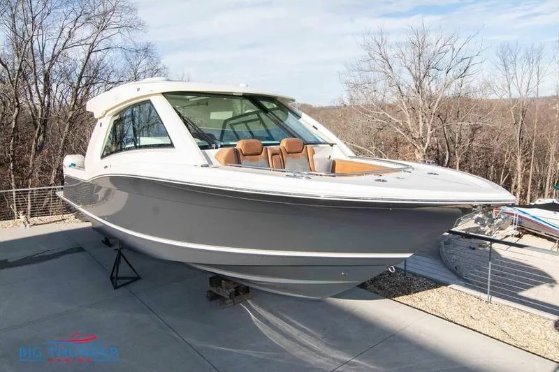  Yacht Photos Pics 2022 Scout 350 LXZ boat displayed outdoors on a sunny day.