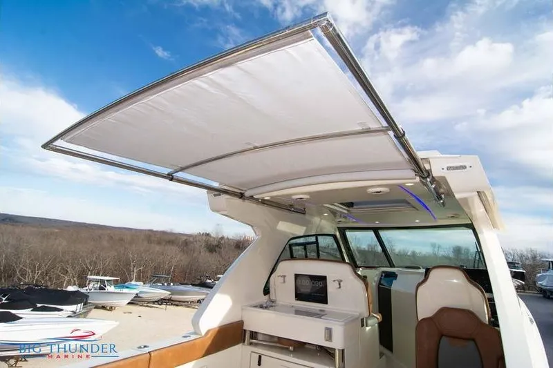  Yacht Photos Pics 2022 Scout 350 LXZ boat with open canopy and modern interior design.