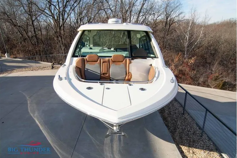  Yacht Photos Pics 2022 Scout 350 LXZ boat with sleek design, docked outdoors in a wooded area.