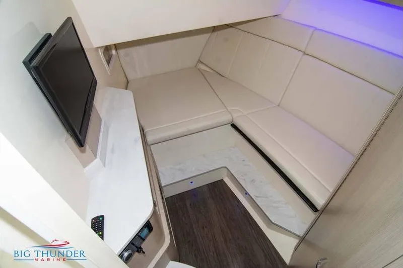 Yacht Photos Pics 2022 Scout 350 LXZ cabin interior with seating, TV, and modern design.
