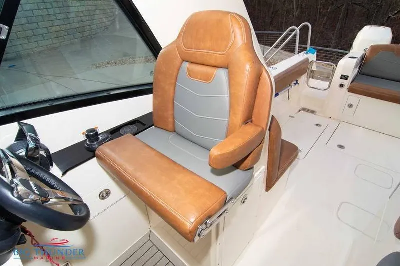  Yacht Photos Pics 2022 Scout 350 LXZ boat interior with tan and gray captain's seat.