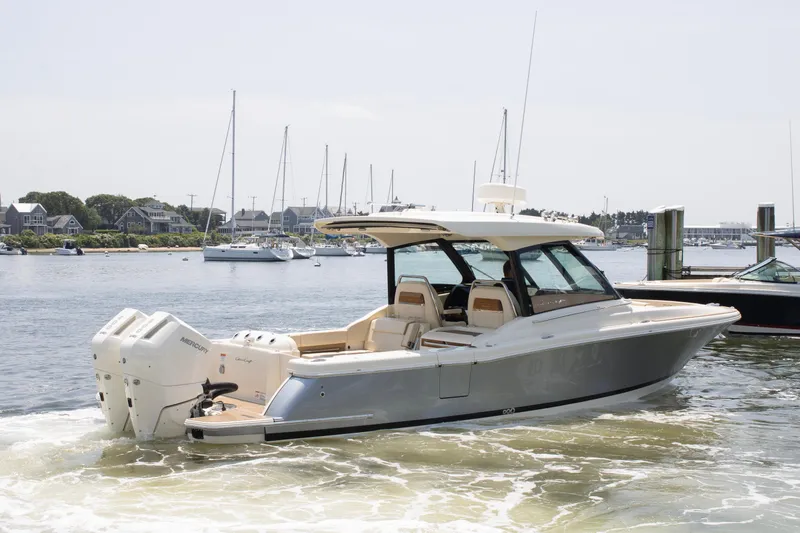  Yacht Photos Pics 2025 Chris-Craft Calypso 32 boat cruising in a marina with scenic background.