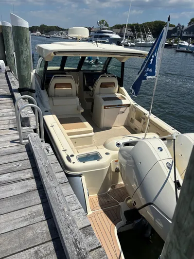  Yacht Photos Pics 2025 Chris-Craft Calypso 32 docked, showcasing spacious seating and modern design.