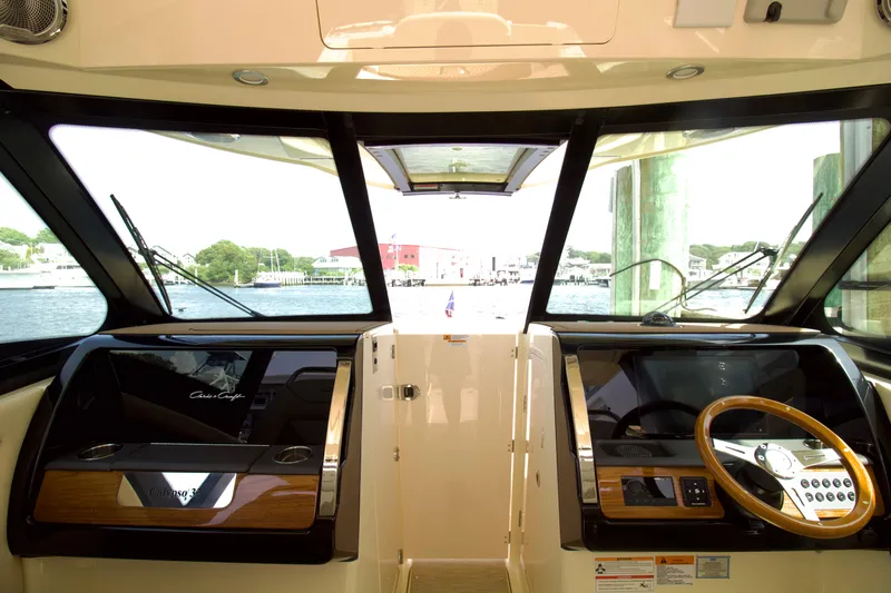  Yacht Photos Pics 2025 Chris-Craft Calypso 32 helm with modern controls and waterfront view.