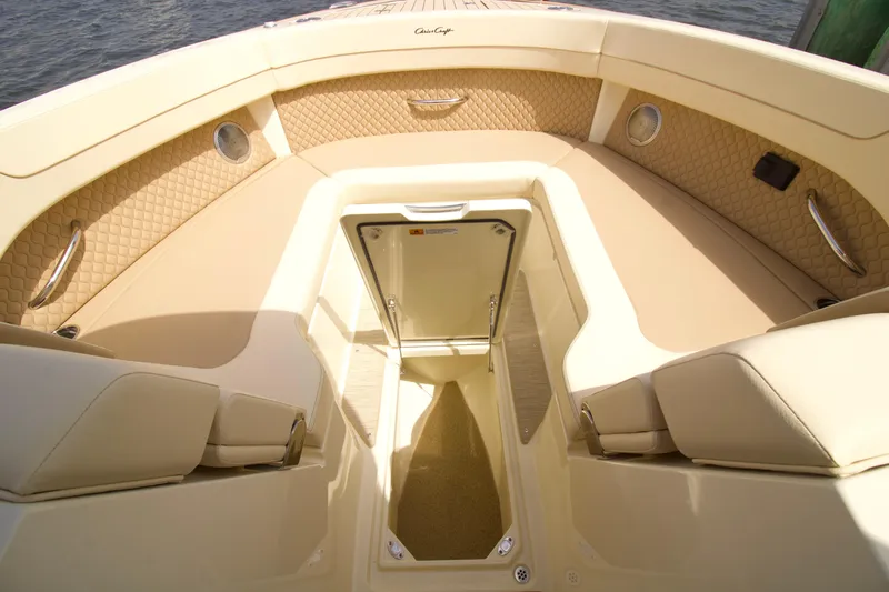  Yacht Photos Pics 2025 Chris-Craft Calypso 32 boat interior with beige seating and storage compartment.