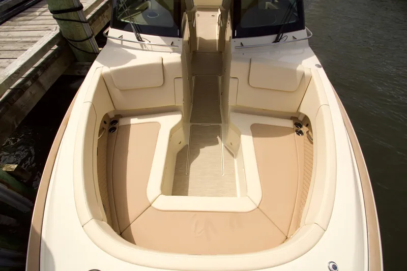  Yacht Photos Pics 2025 Chris-Craft Calypso 32 boat interior with beige seating and wooden deck.