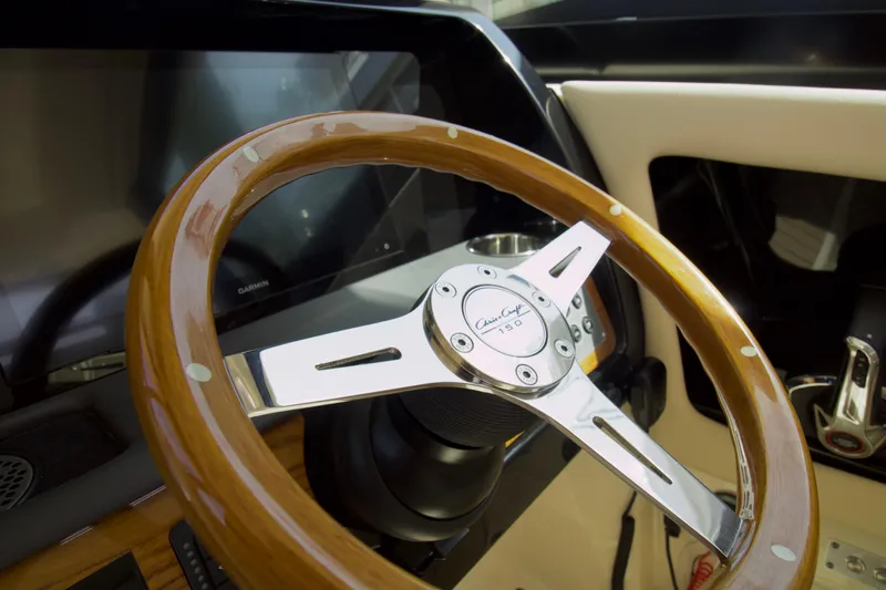  Yacht Photos Pics 2025 Chris-Craft Calypso 32 steering wheel, featuring elegant wood and chrome design.