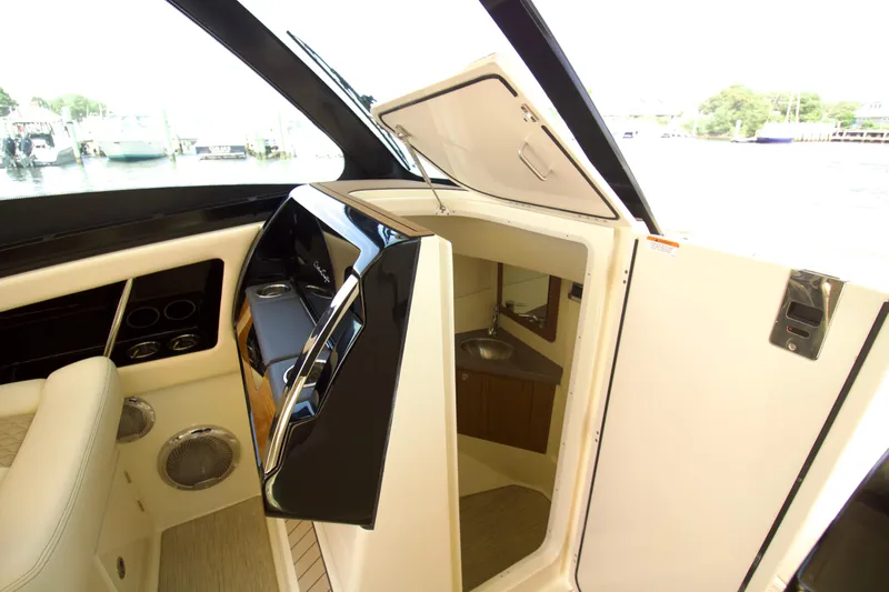  Yacht Photos Pics 2025 Chris-Craft Calypso 32 interior with helm and cabin entrance.