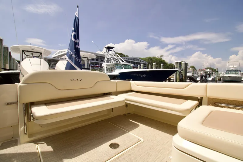  Yacht Photos Pics 2025 Chris-Craft Calypso 32 boat interior with beige seating at a marina.