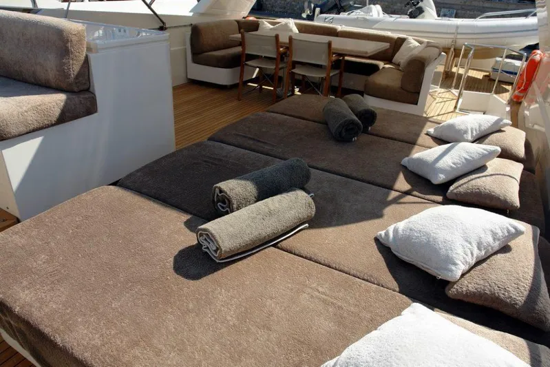 Yacht Photos Pics Sanlorenzo SL88 2006 yacht deck with sun loungers, towels, and seating area.