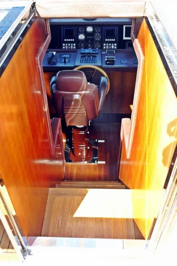  Yacht Photos Pics 2006 Sanlorenzo SL88 yacht helm station with leather captain's chair and control panel.