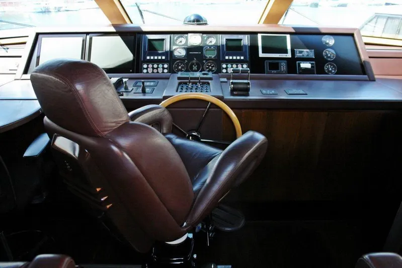  Yacht Photos Pics Helm station of 2006 Sanlorenzo SL88 yacht with leather captain's chair and advanced navigation controls.