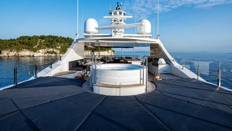  Yacht Photos Pics Luxurious Ortona Navi ZIA yacht deck with jacuzzi, surrounded by serene sea and lush greenery.