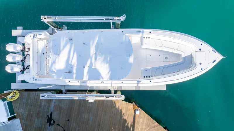  Yacht Photos Pics Aerial view of 2019 Intrepid 400 Center Console boat docked on turquoise water.