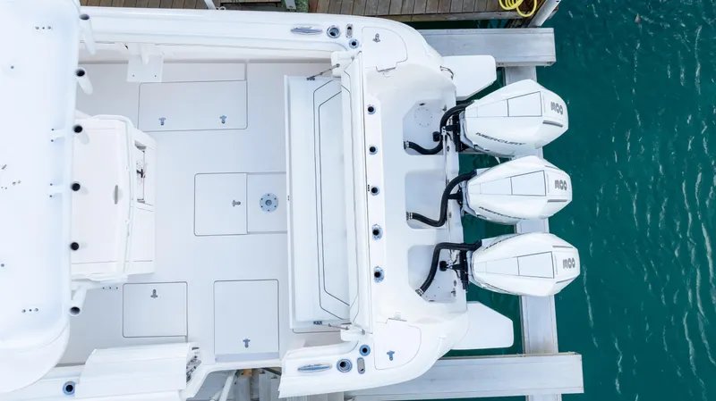  Yacht Photos Pics 2019 Intrepid 400 Center Console boat with triple outboard engines, docked in turquoise water.