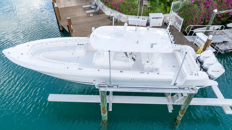  Yacht Photos Pics 2019 Intrepid 400 Center Console boat docked on a lift in clear blue water.