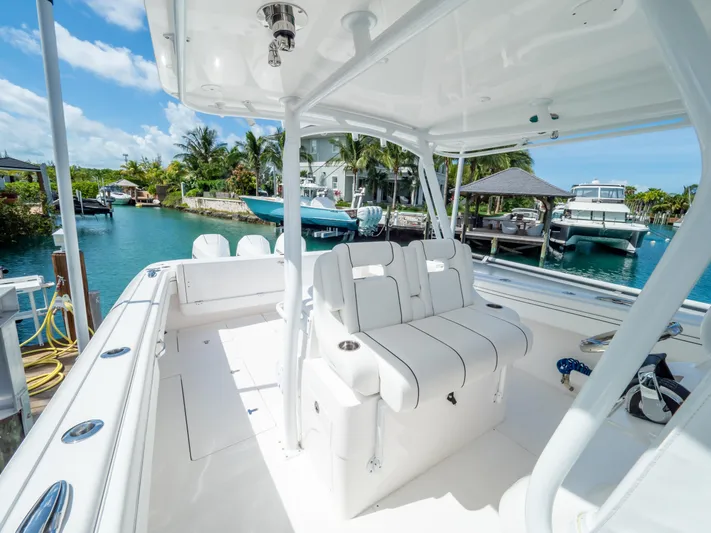  Yacht Photos Pics 2019 Intrepid 400 Center Console boat with white seating, docked in a tropical marina.