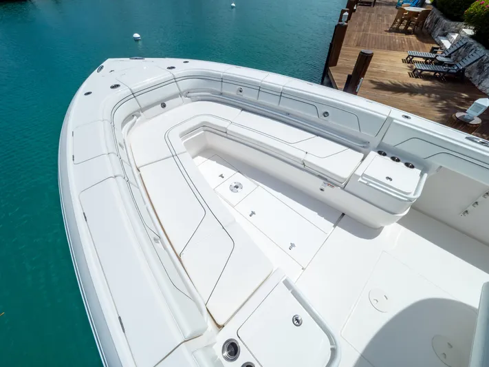  Yacht Photos Pics 2019 Intrepid 400 Center Console boat with spacious seating, docked by turquoise water.