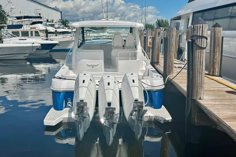  Yacht Photos Pics 2026 Intrepid 50 Evolution boat docked with triple outboard engines.