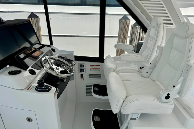  Yacht Photos Pics Luxurious helm of 2026 Intrepid 50 Evolution yacht with white leather seats.