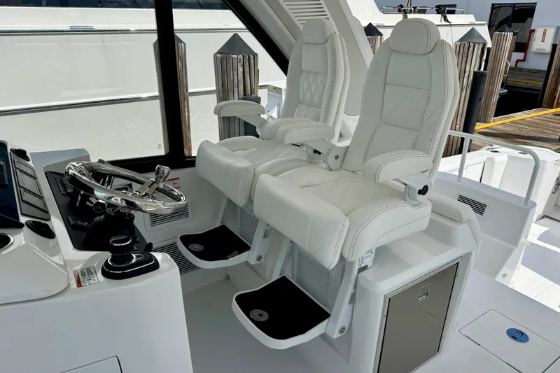  Yacht Photos Pics Luxury helm seating on 2026 Intrepid 50 Evolution yacht, featuring sleek design and modern controls.