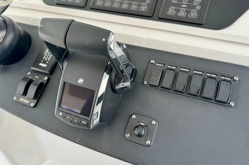  Yacht Photos Pics Control panel of 2026 Intrepid 50 Evolution boat with switches and throttle.