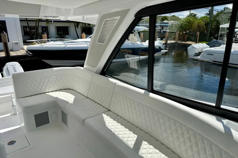  Yacht Photos Pics Luxurious interior of 2026 Intrepid 50 Evolution yacht with white quilted seating.